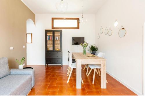 a living room with a table and chairs and a couch at Casa Maria in Nesso