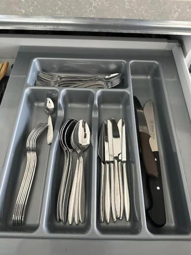 a tray with utensils in a kitchen sink at SİNPAŞ QUEEN BOMONTİ 320 in Istanbul