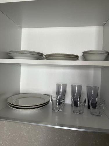 a row of glasses and plates on a shelf at SİNPAŞ QUEEN BOMONTİ 320 in Istanbul