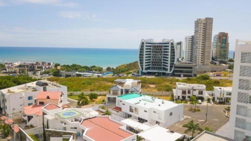 an aerial view of a city with buildings and the ocean at Beautiful LOFT in front of Wyndham Hotel in Manta