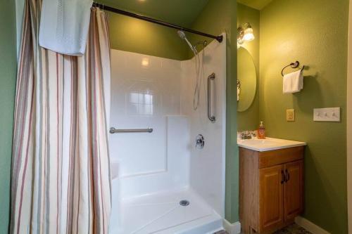 a bathroom with a shower and a tub and a sink at Elk Meadow Cabins 19B Johnny Redwood - Single Room in Orick