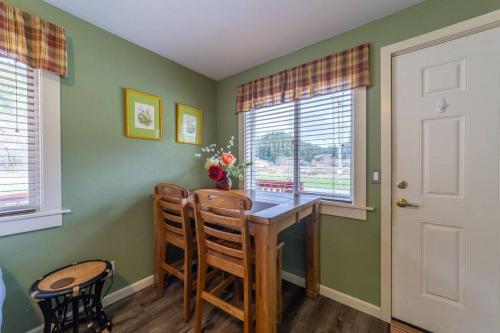 a dining room with a table and two chairs at Elk Meadow Cabins 19B Johnny Redwood - Single Room in Orick