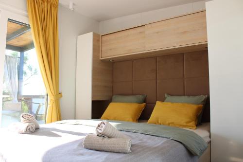 a bedroom with a large bed with towels on it at Sha-Shaaa Luxury Mobile Home - Terra Park SpiritoS in Kolan