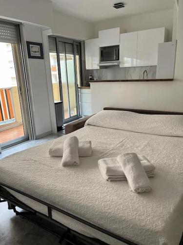 une chambre avec un lit avec des serviettes dessus dans l'établissement Studio entre plages et Monaco climatisé parking, à Roquebrune-Cap-Martin