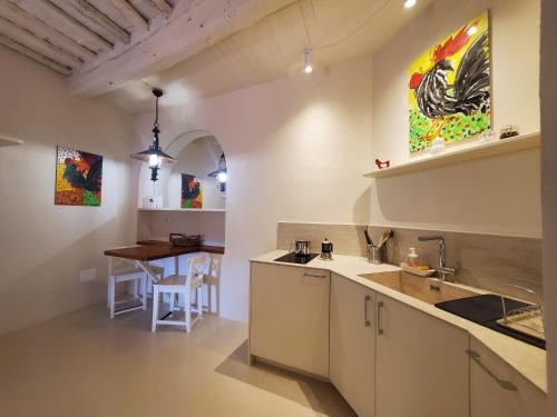 kuchnia ze zlewem i stołem w obiekcie CASINA TOSCANA, Cozy studio in the heart of Campiglia Marittima with FREE Wi-Fi w mieście Campiglia Marittima