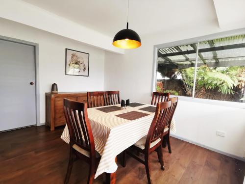 a dining room with a table and chairs at 4 bdm house+sleep-out in Pukete.Close to The Base in Hamilton