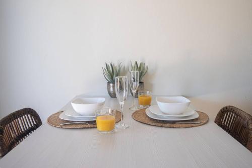 a table with plates and glasses of orange juice at Villa Oasis in Palm-Eagle Beach