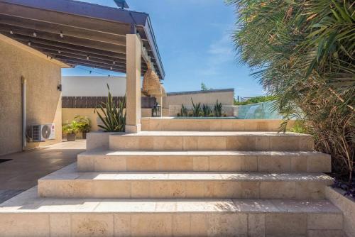 a set of concrete stairs leading to a house at Villa Oasis in Palm-Eagle Beach