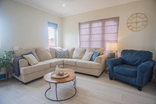 a living room with a couch and a chair and a table at Villa Oasis in Palm-Eagle Beach