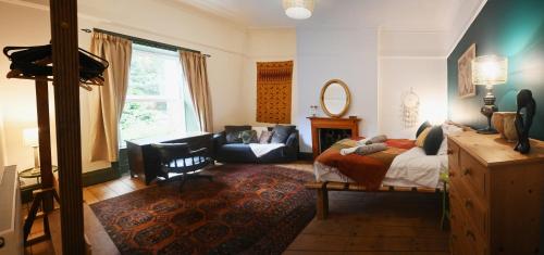 a bedroom with a bed and a living room at Hope House, Hebden's Hidden Gem in Hebden Bridge