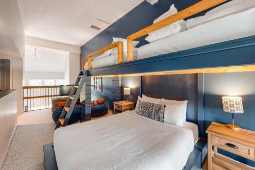 a bedroom with two bunk beds and a desk at Wintergreen 126 in Blue Mountains