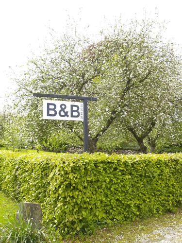 a street sign in front of a hedge at Juhl's Bed & Breakfast in Kolding