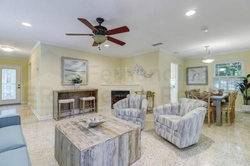 a living room with a ceiling fan and a fireplace at 223 Lighthouse Circle home in Fernandina Beach