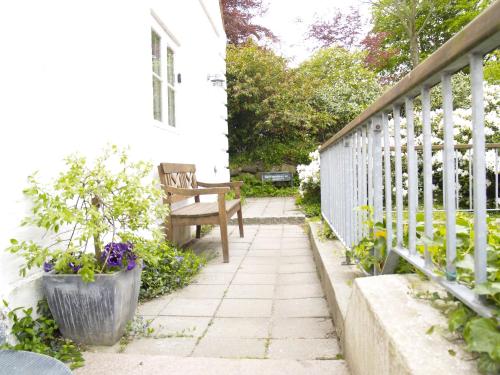a porch with a bench and a fence at Juhl's Bed & Breakfast in Kolding