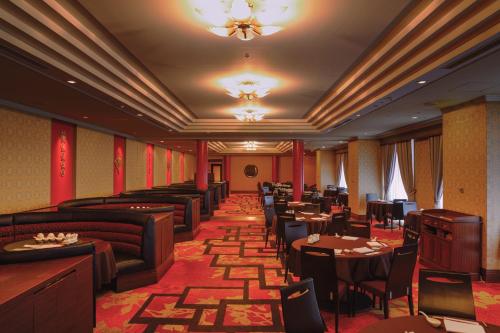 a restaurant with couches and tables and chairs at Shinagawa Prince Hotel East Tower in Tokyo