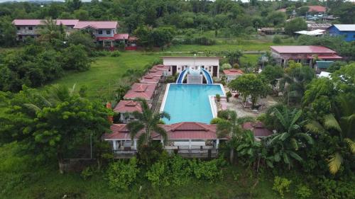 an aerial view of a pool at a resort at Pilot Hotel powered by Cocotel in Alaminos