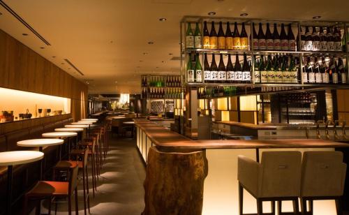 a bar with tables and chairs and bottles of wine at Shinagawa Prince Hotel East Tower in Tokyo
