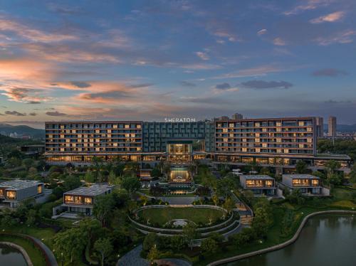 an aerial view of a hotel with a lake in front at Sheraton Ninghai in Ninghai