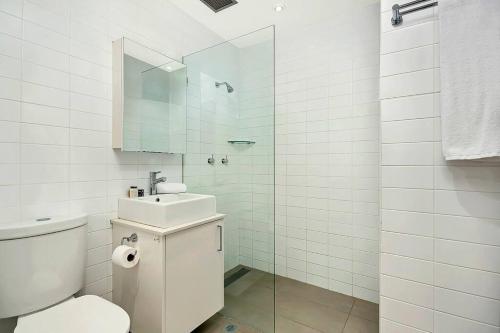 a bathroom with a toilet and a sink and a shower at CLDON- furnished 1 bedroom - Bridge St Sydney CBD in Sydney