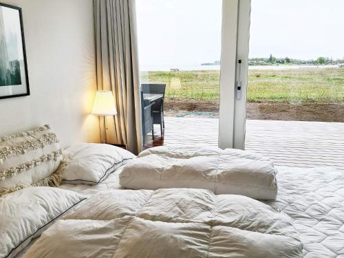 two beds sitting in a room with a window at Holiday home Haderslev XXVI in Haderslev