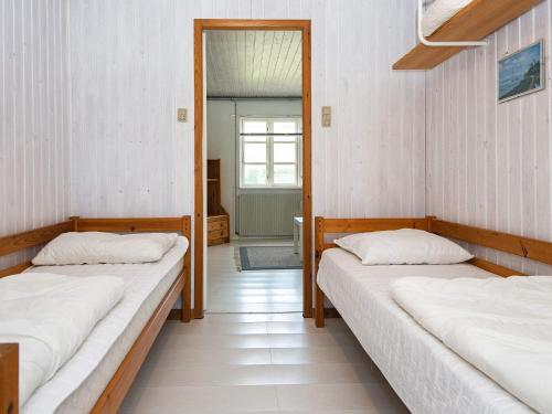two beds in a room with a mirror at Seaside Escape in Kegnaes - By Traum Ferienwohnungen in Østerby