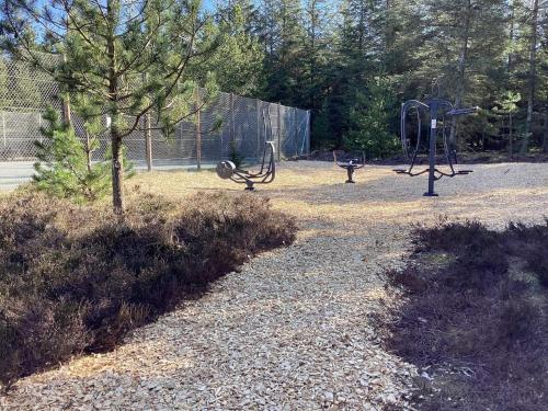 a park with a playground with two swings at 8 person holiday home in Fjerritslev-By Traum in Fjerritslev
