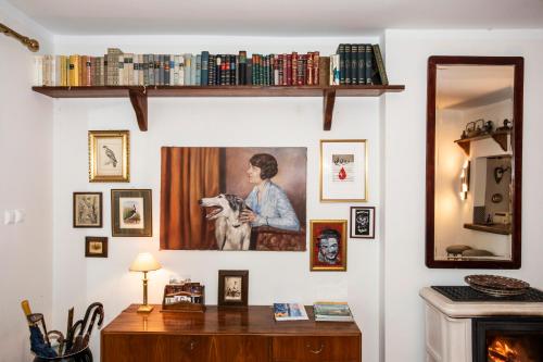 a room with a desk and a painting of a woman with a dog at Gästehaus Wallner in Velden am Wörthersee