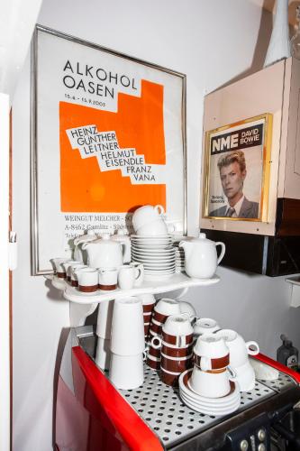 a bunch of cups and plates on a shelf at Gästehaus Wallner in Velden am Wörthersee