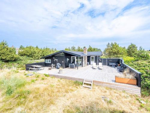 a house on the beach with a deck at 6 person holiday home in Henne in Henne Strand