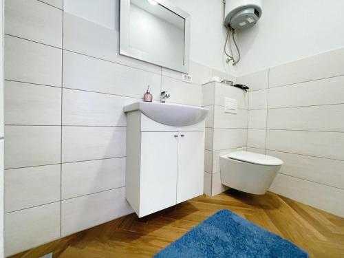 a bathroom with a sink and a toilet at Apartment Candy in Pula