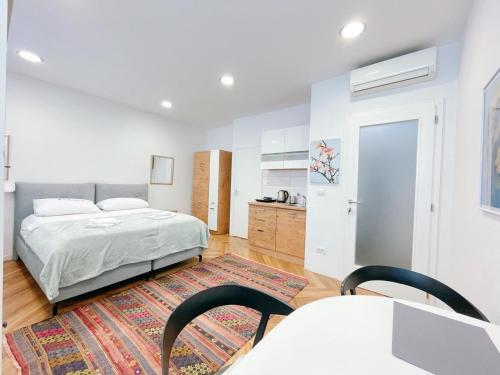 a bedroom with a bed and a table and chairs at Apartment Candy in Pula
