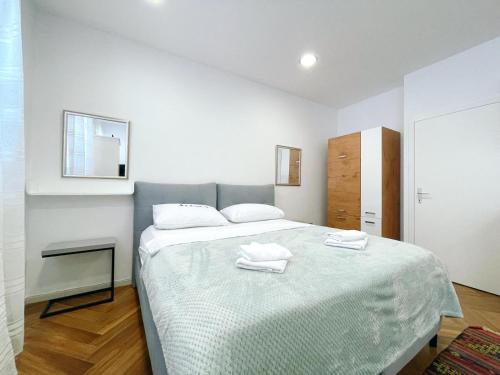 a bedroom with a bed with two towels on it at Apartment Candy in Pula
