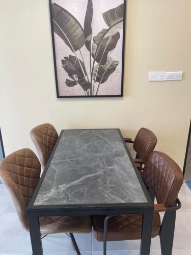 a black table and chairs in a room at Sandakan Homestay Coastal Serenity 山海绿栖 in Sandakan