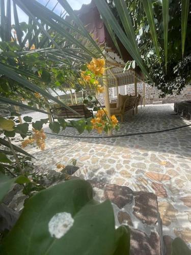 a patio with chairs and plants in a garden at Alsalam Farmhouse in Hatta