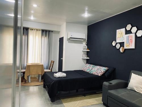 a living room with a bed and a couch at AKC AirBNB in Mandaue City