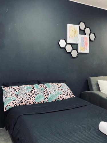 a bedroom with a bed and a black wall at AKC AirBNB in Mandaue City
