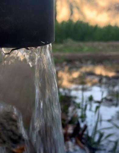 a close up of water pouring out of a fire hydrant at Alsalam Farmhouse in Hatta
