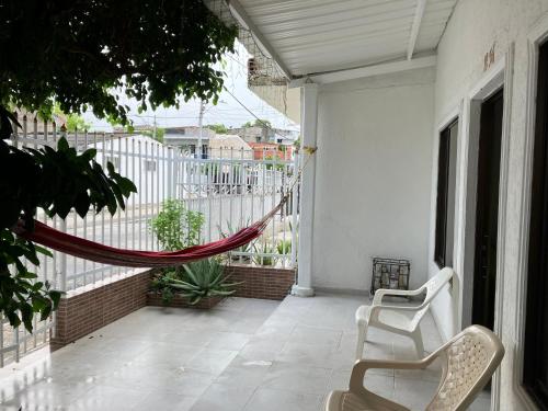 a porch with a hammock on a house at Casa Encanto Cartagena Colombia in Cartagena de Indias