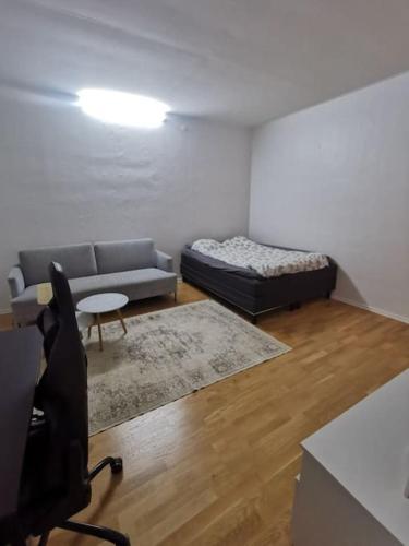 a living room with a couch and a bed at Studio in Malmö