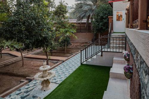 a house with a swimming pool with a green lawn at Hatta Orchard in Hatta