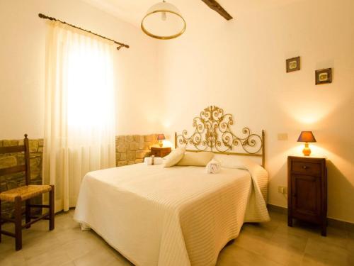 um quarto com uma cama com um cobertor branco e uma janela em Belvilla by OYO Noce em Donnini
