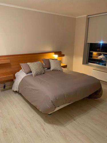 a large bed in a bedroom with a window at vacaciones con laguna in Algarrobo