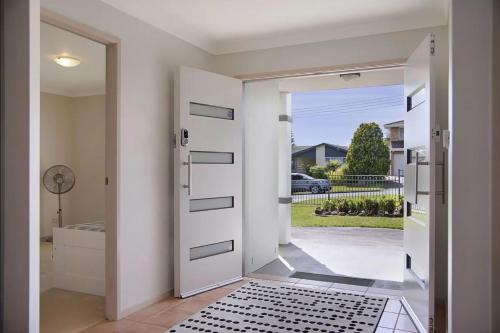 a pivot door in a home with a bathroom at Kokomo on Village in Ulladulla