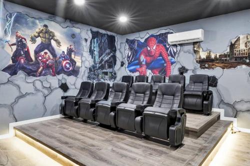 a movie room with a superhero mural on the wall at Magical Retreat in Kissimmee