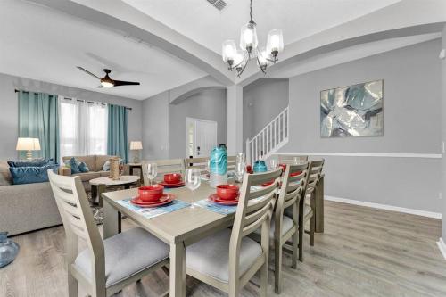 a dining room and living room with a table and chairs at Magical Retreat in Kissimmee