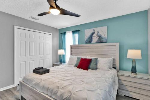 a bedroom with a large bed with a ceiling fan at Magical Retreat in Kissimmee