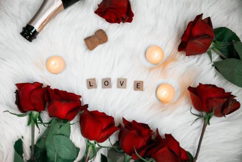 a circle of red roses and candles with the word love at Ocean Sands Beach Boutique Inn-1 Acre Private Beach-St Augustine Historic-2 Miles-Shuttle with Downtown Tour-HEATED Salt Water Pool until 420AM-Popcorn-Cookies-New 4k USD Black Beds- 69 Item Breakfast-Eggs-Bacon-Starbucks- Free Laundry- #904-799-SAND in Saint Augustine
