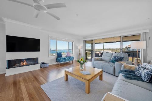 a living room with a couch and a fireplace at Foredeck Views at Manyana in Manyana