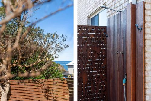 a fence and a wooden door with the ocean in the background at Foredeck Views at Manyana in Manyana