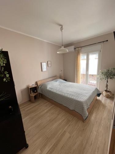 a bedroom with a bed and a large window at inHeart Apartment Chios in Chios